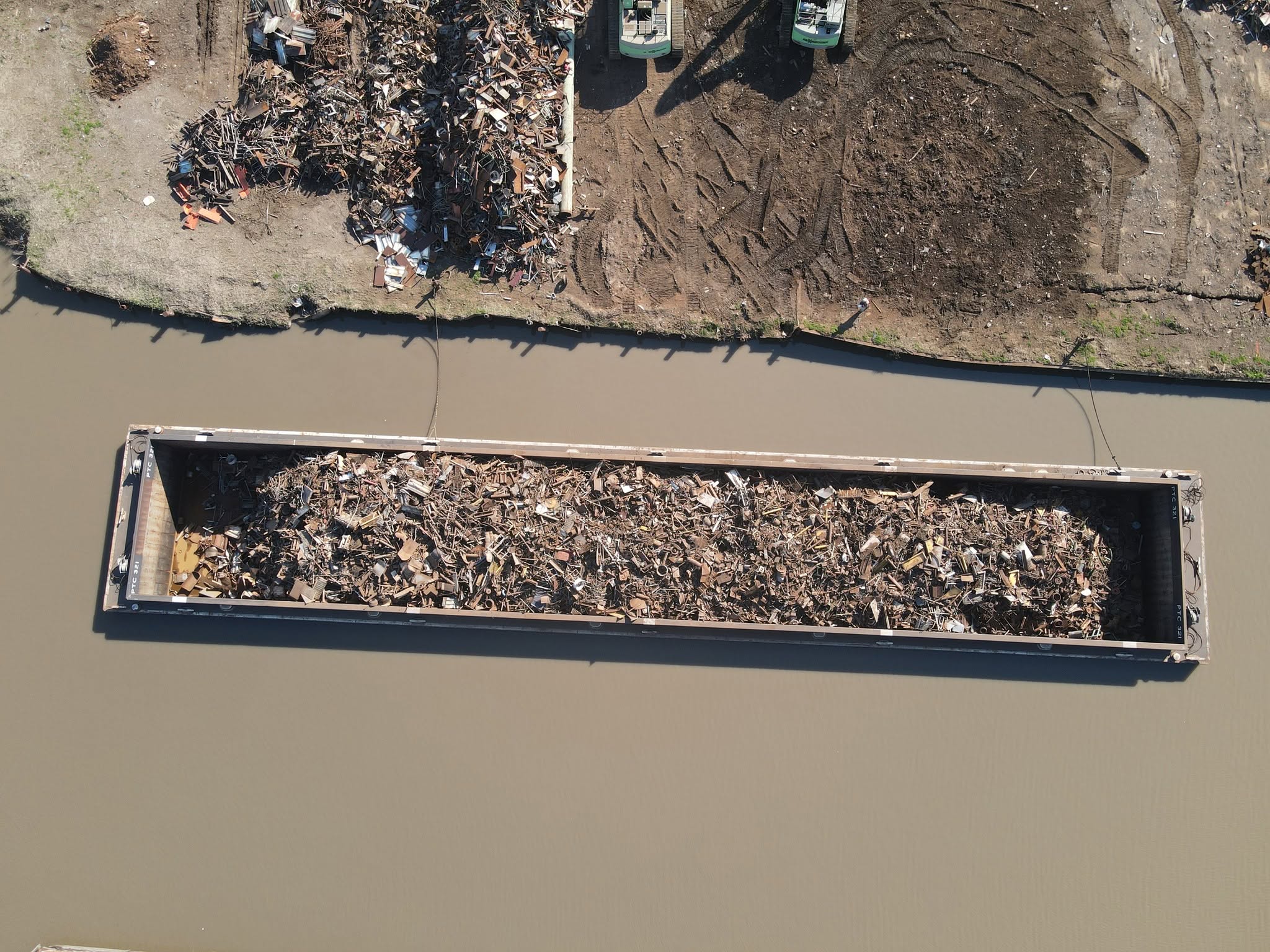 Barge loaded with scrap metal beside the yard